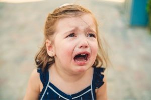 A child crying because of parents' physical abuse in Portland.