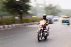 Man riding a motorcycle at a dangerous speed level.