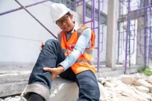 A construction worker with an injured leg.