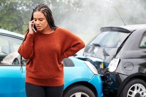 A woman calling her lawyer after a highway-roadway accident in Vancouver, WA.