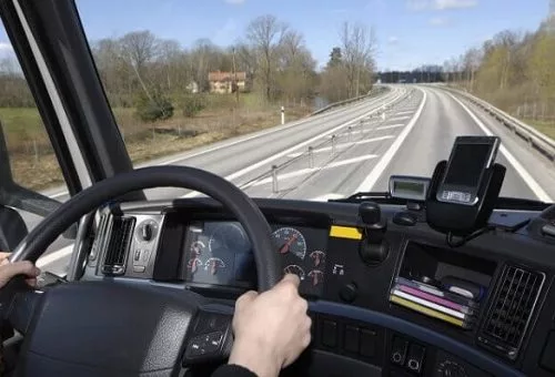 A truck driver driving on a highway